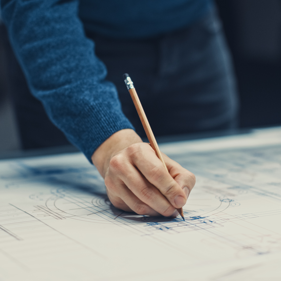 Man's hand with pencil and technical drawing design