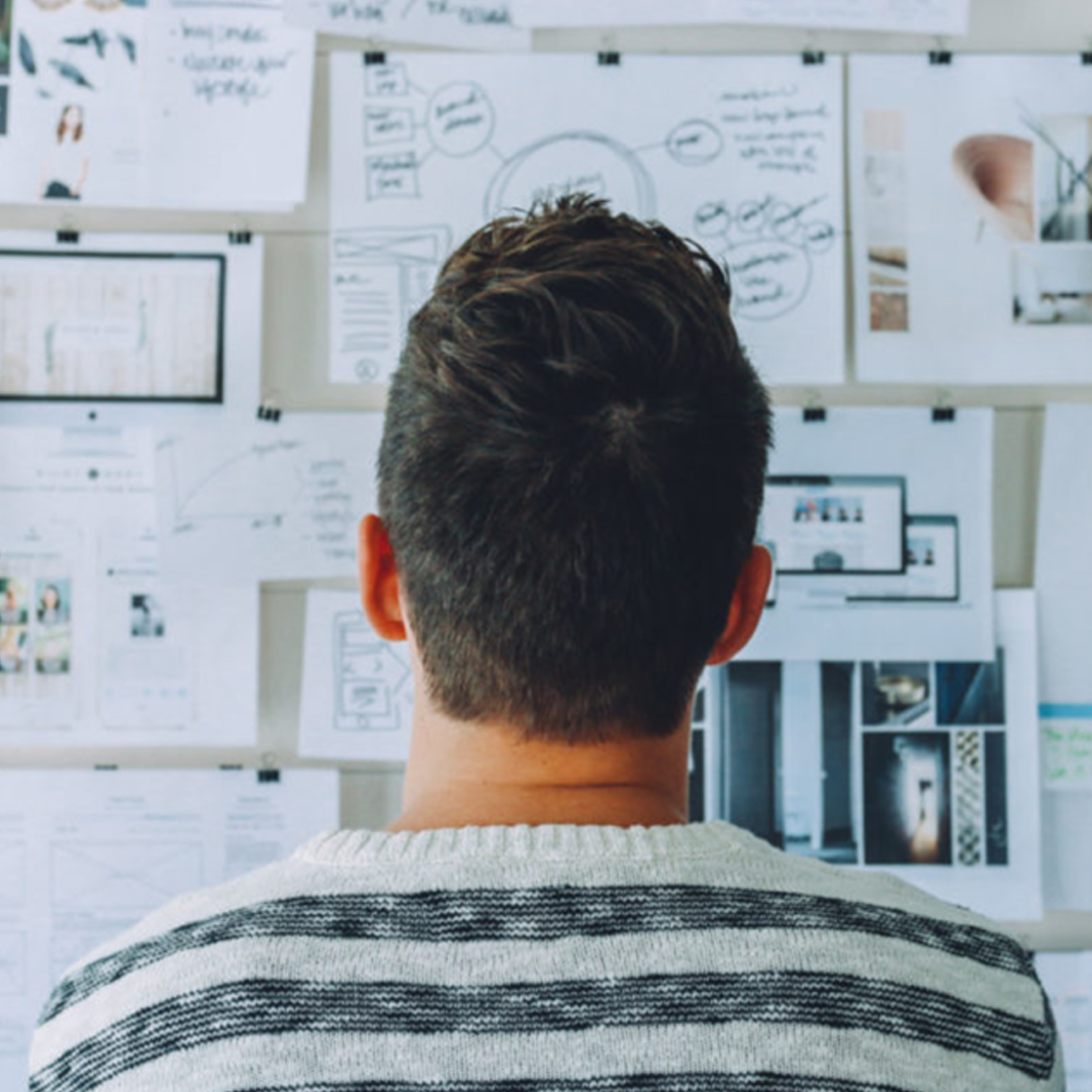 Man viewing project management plan reminders on wall